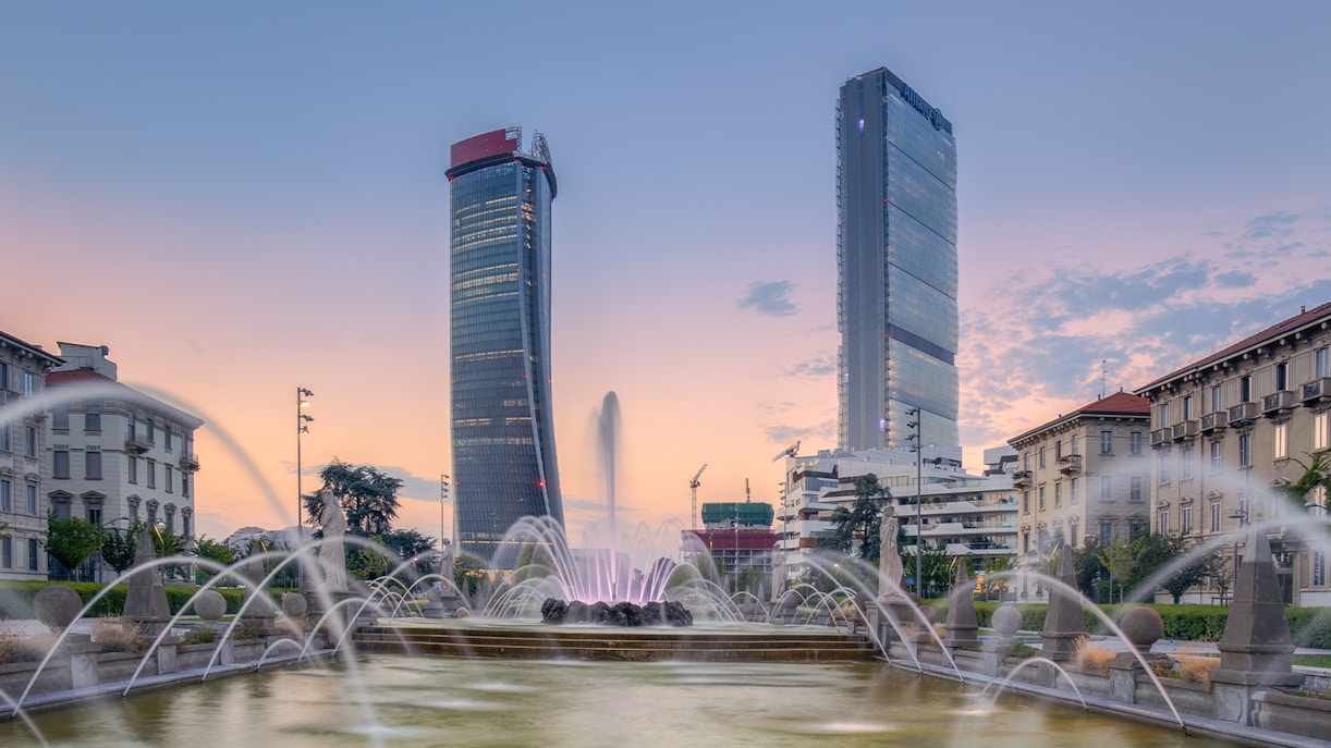 Milan cityscape with bustling streets and historic architecture.