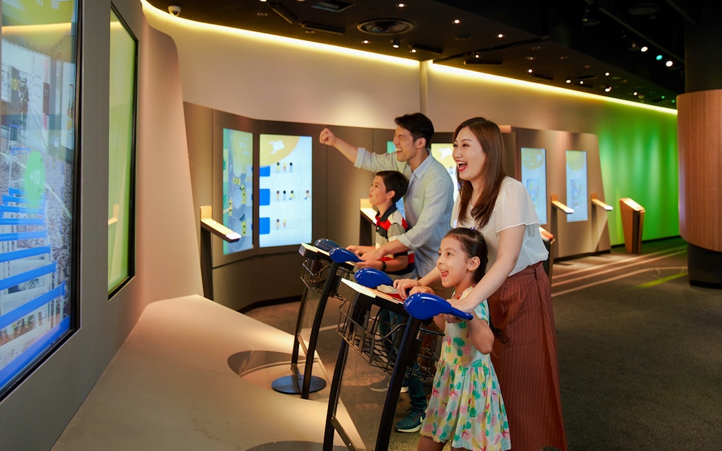 Family enjoying interactive games at Changi Experience Studio, Singapore.