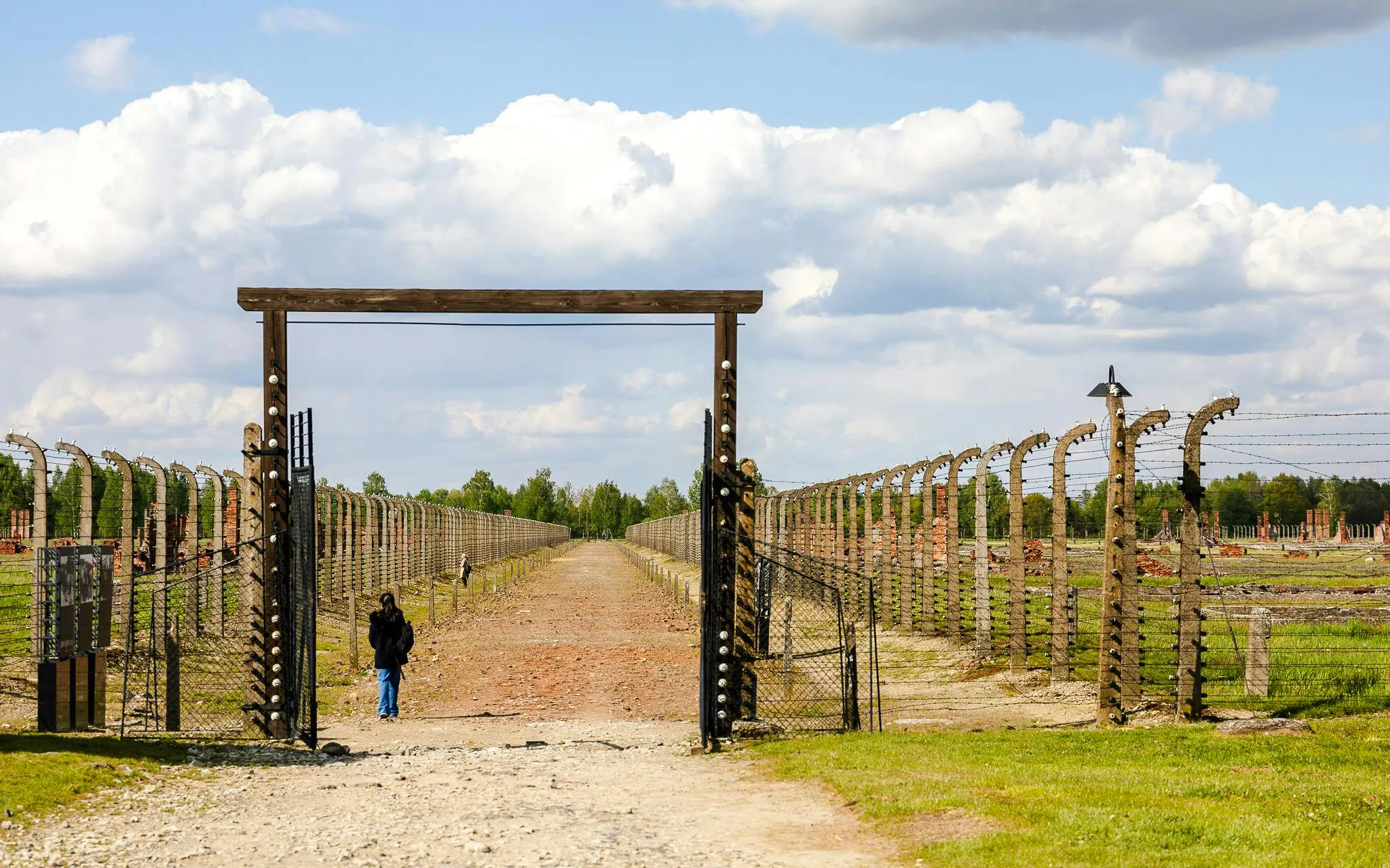 Visitors walking through the gates of Auschwitz on a guided tour.