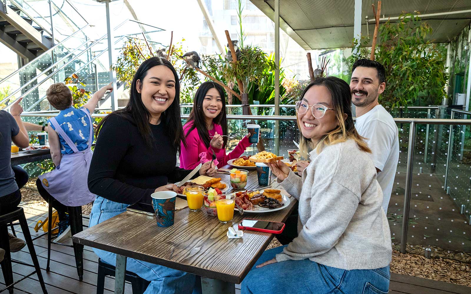 Visitors enjoying breakfast with koalas at WILD LIFE Sydney Zoo.