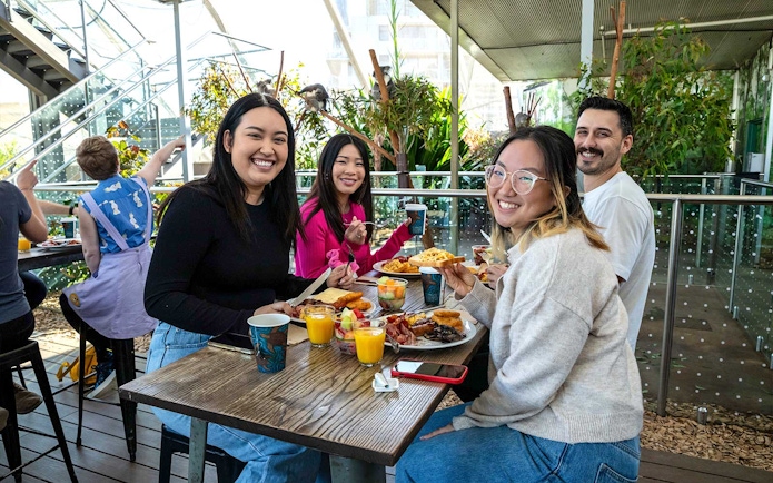 Visitors enjoying breakfast with koalas at WILD LIFE Sydney Zoo.