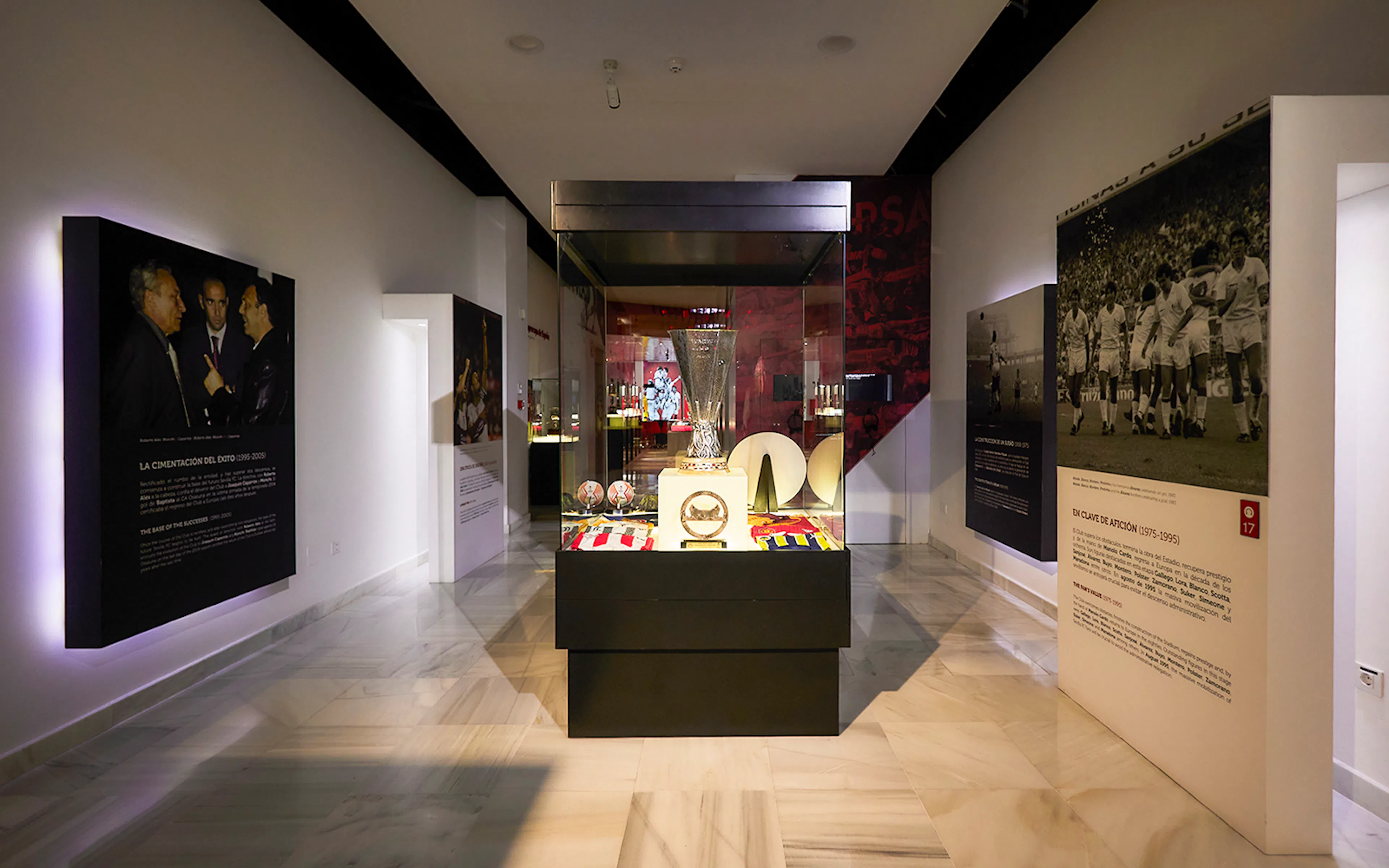 Sevilla FC History Experience museum interior with trophy display and historical panels.