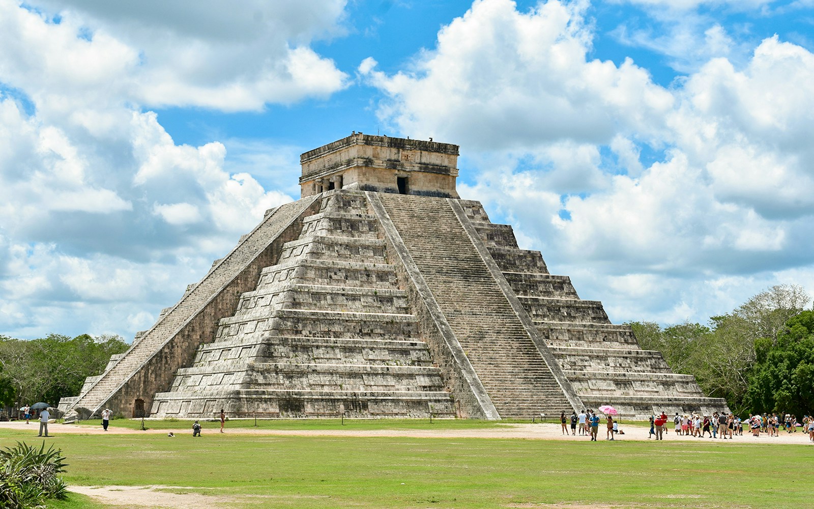 Tourists exploring the pyramid at Chichen Itza, Mexico.