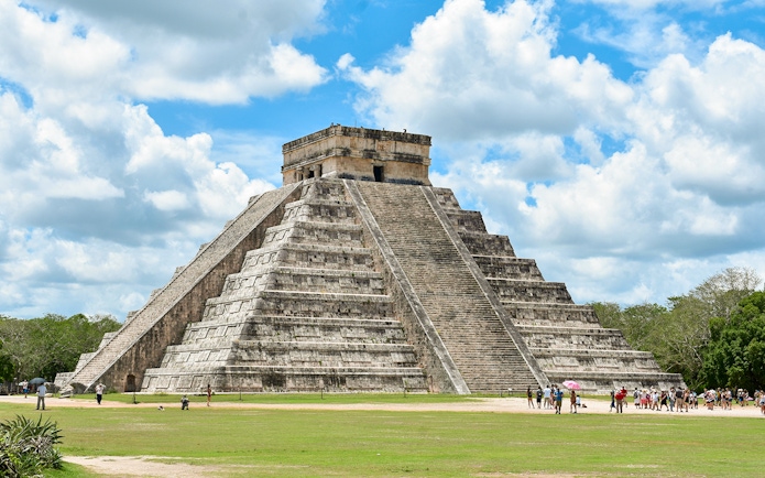 Tourists exploring the pyramid at Chichen Itza, Mexico.