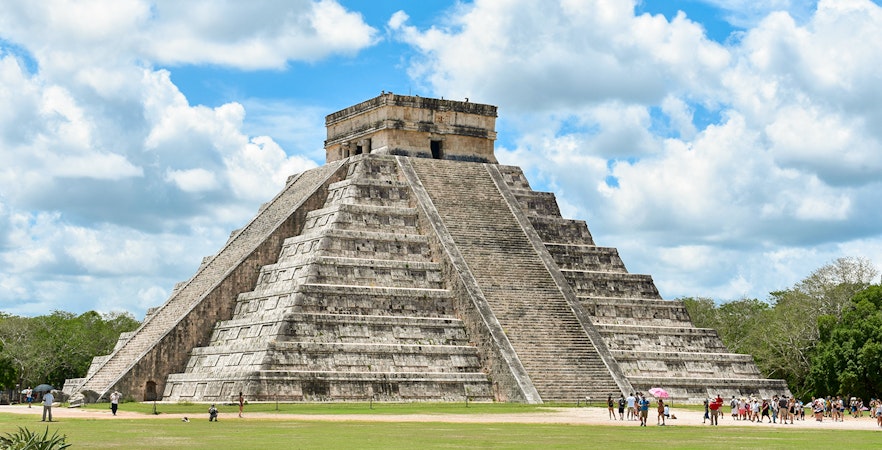 Tourists exploring the pyramid at Chichen Itza, Mexico.