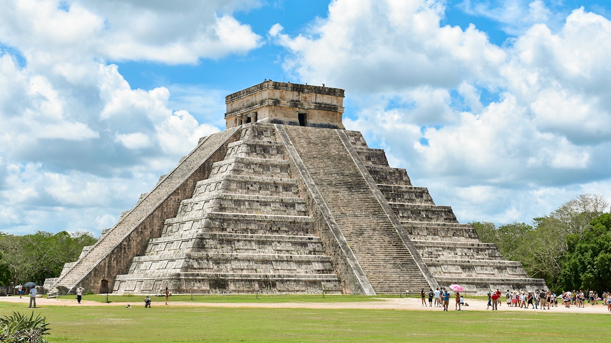 Tourists exploring the pyramid at Chichen Itza, Mexico.