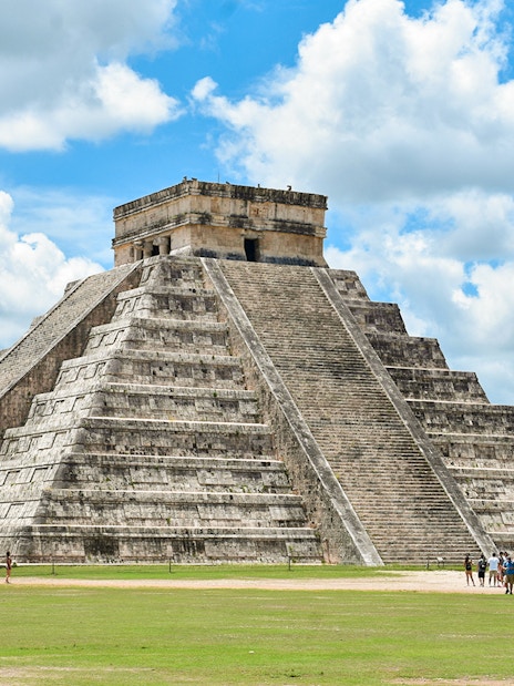 Tourists exploring the pyramid at Chichen Itza, Mexico.