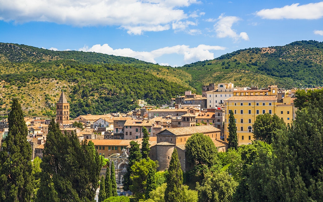 Tivoli townscape with lush greenery near Villa d'Este gardens, Italy.