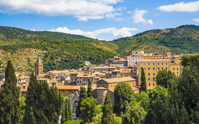 Tivoli townscape with lush greenery near Villa d'Este gardens, Italy.