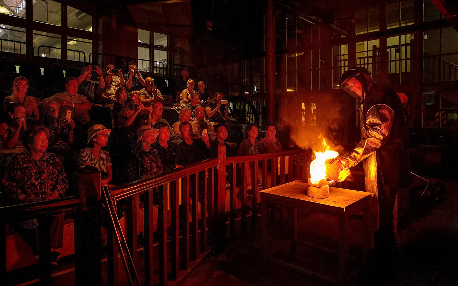 Audience watching a live metal pouring demonstration in Perth.