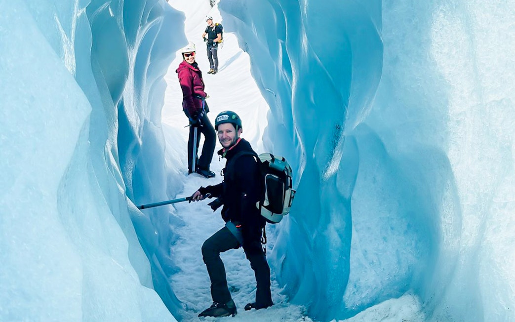 Guests exploring ice cave during Vatnajökull glacier expedition.