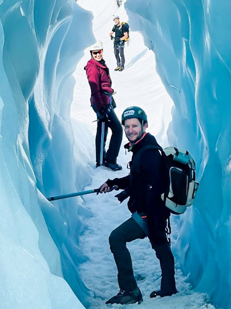 Guests exploring ice cave during Vatnajökull glacier expedition.