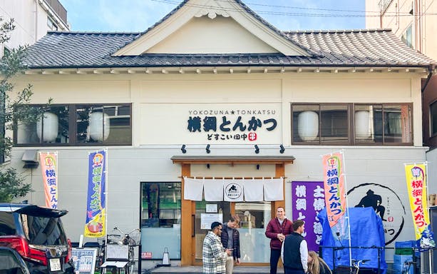 Sumo show entry at Yokozuna Tonkatsu restaurant in Japan.