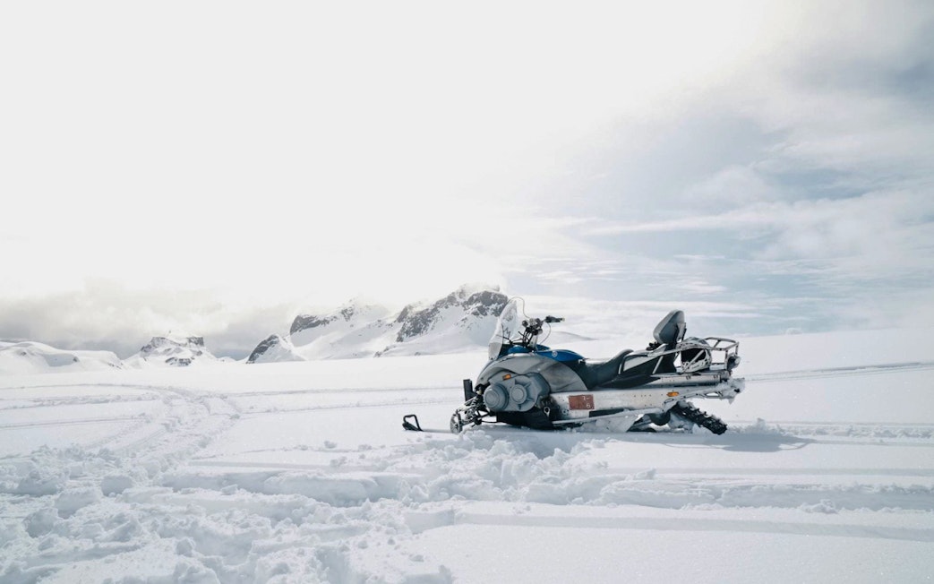 Snowmobile on snowy terrain near Gullfoss waterfall, Iceland.