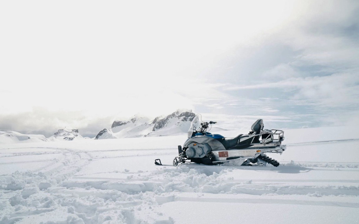 Snowmobile on snowy terrain near Gullfoss waterfall, Iceland.
