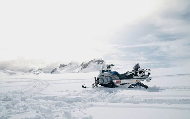 Snowmobile on snowy terrain near Gullfoss waterfall, Iceland.