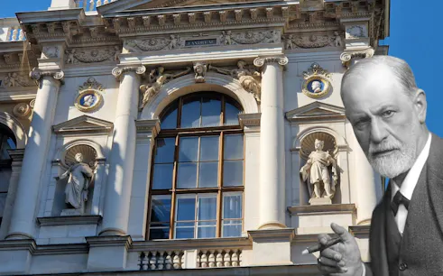 Historic Vienna building facade with statues, part of Freud's self-guided city exploration game.