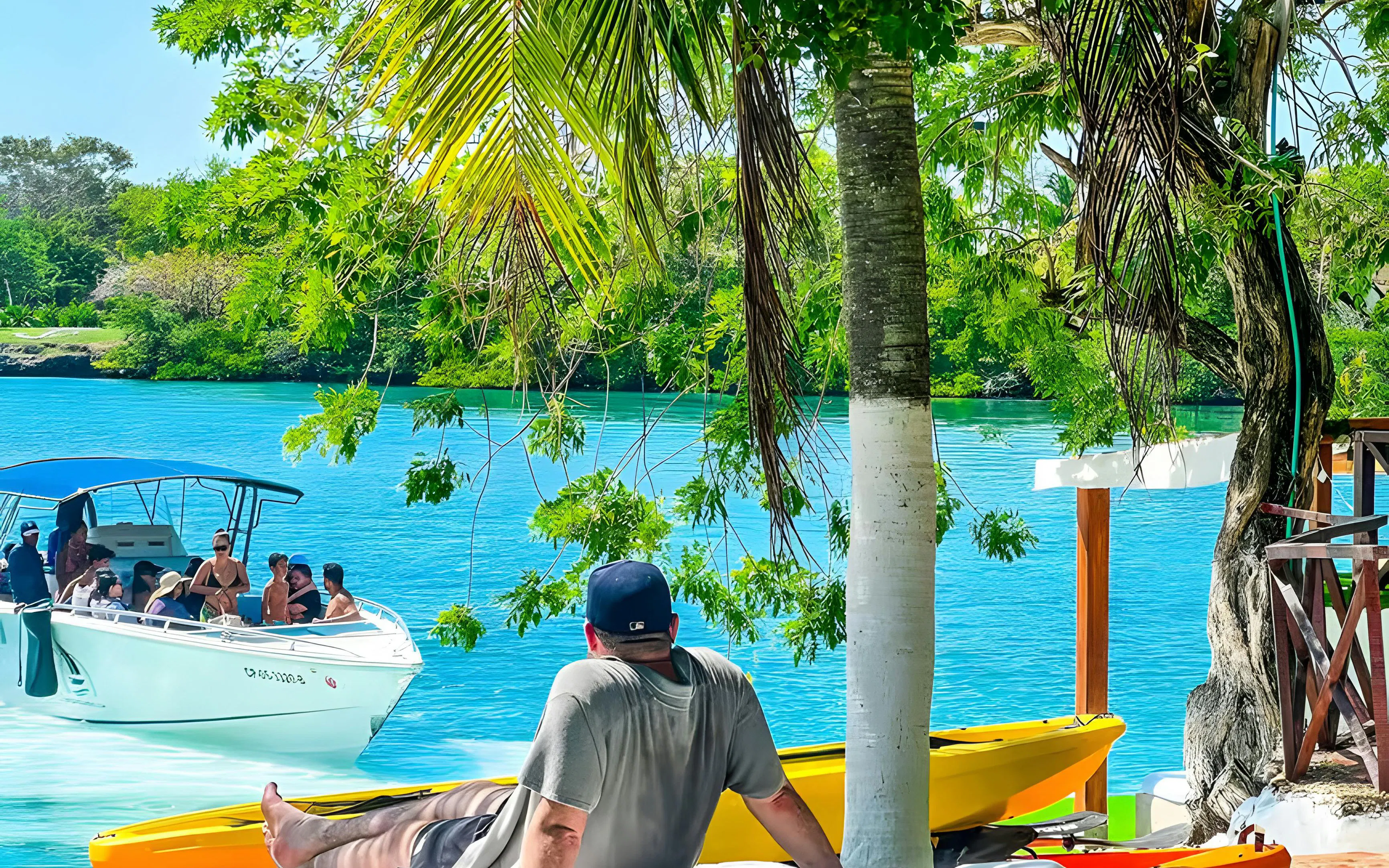 Tourist relaxing by the water with a boat in Rosario Islands, Cartagena, Colombia.