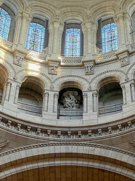 Interior view of Sacre Coeur dome with stained glass and angel sculptures, Montmartre, Paris.