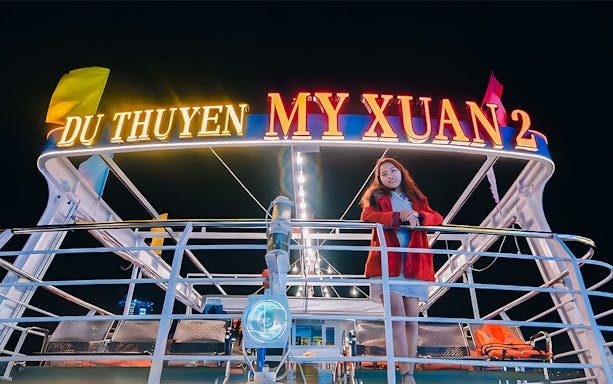 My Xuan cruise ship on Han River at night with a person on deck.