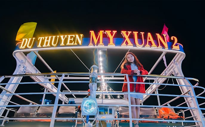 My Xuan cruise ship on Han River at night with a person on deck.