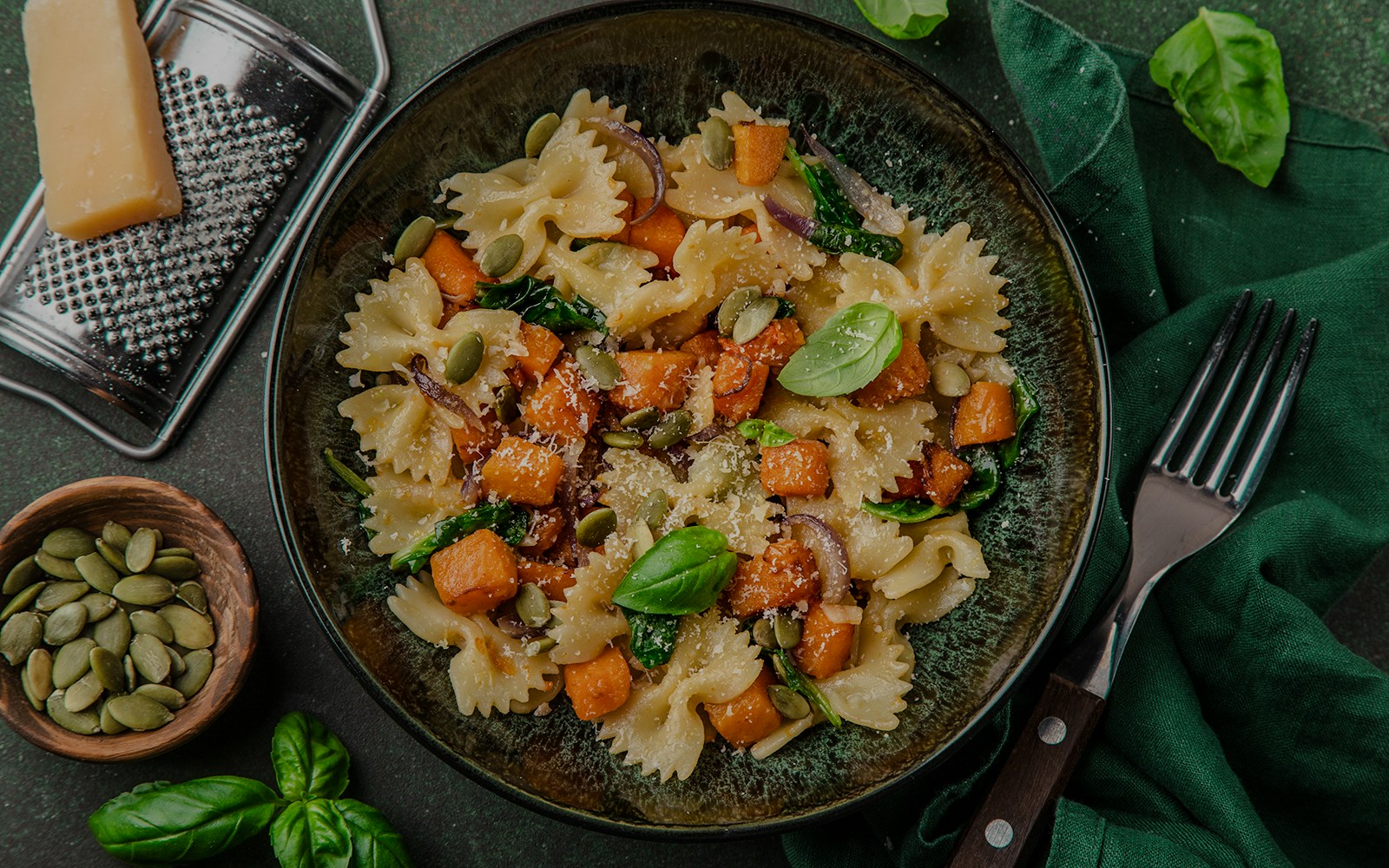 Farfalle pasta with pumpkin, spinach, and seeds on a plate, Moulin Rouge tour.