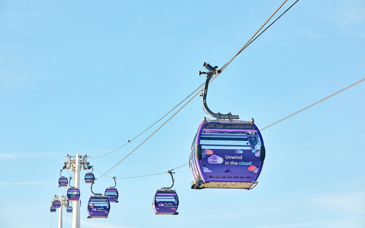 IFS Cloud Cable Car in London against a clear blue sky.
