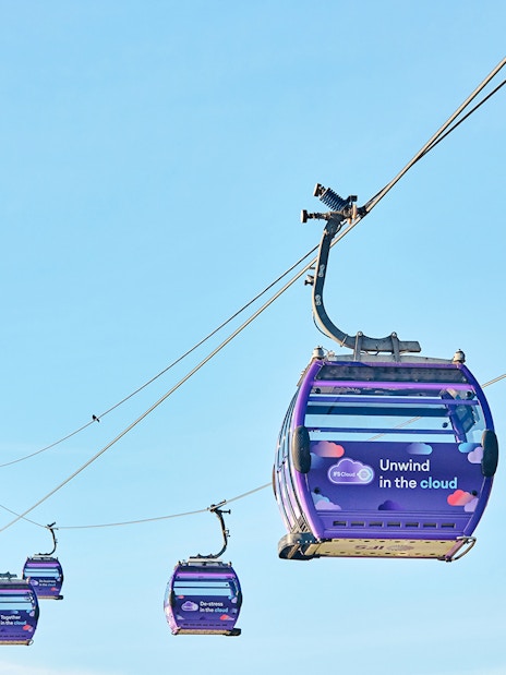 IFS Cloud Cable Car in London against a clear blue sky.