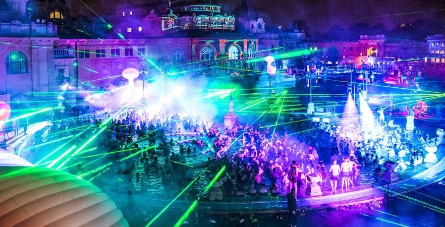 Crowd enjoying a laser show at Sparty Budapest in Széchenyi Thermal Bath.
