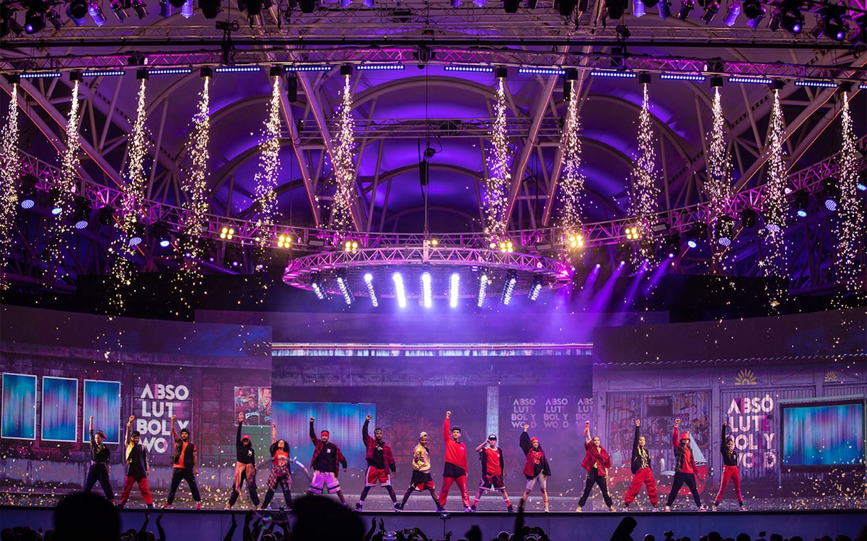 Bollywood dance performance with fireworks at Global Village Dubai stage.
