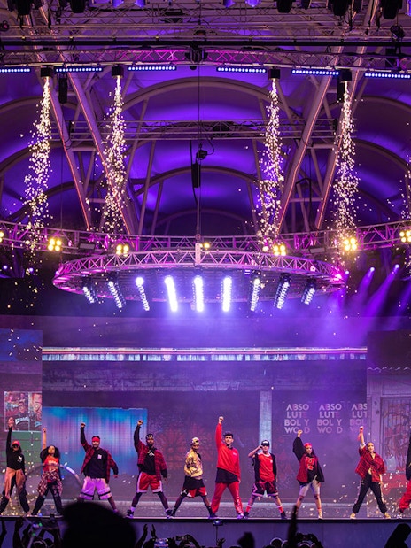 Bollywood dance performance with fireworks at Global Village Dubai stage.