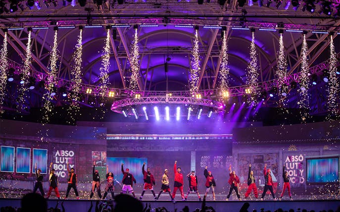Bollywood dance performance with fireworks at Global Village Dubai stage.