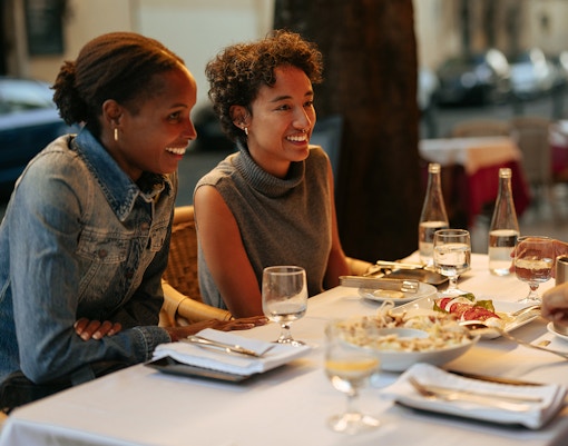 Tourists dining at a Rome restaurant with friends.