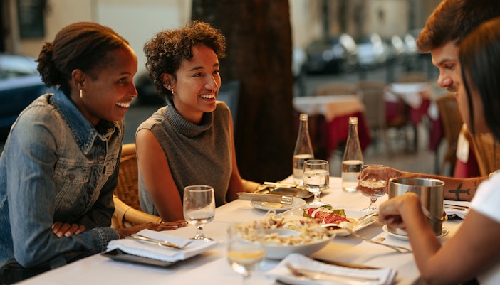 Tourists dining at a Rome restaurant with friends.