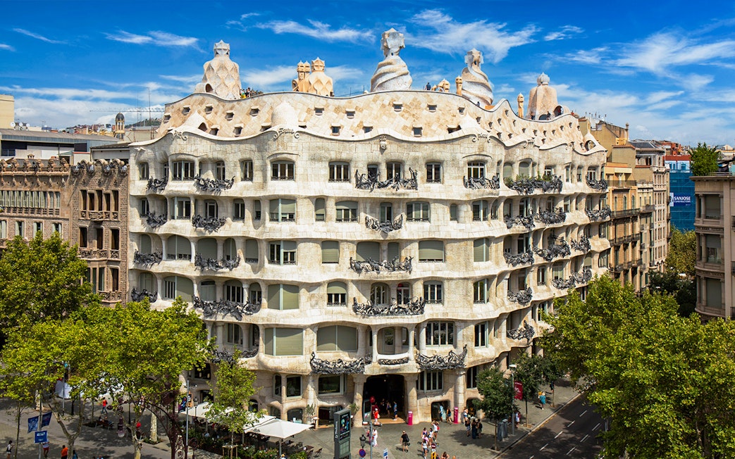 Casa Mila rooftop with unique chimneys in Barcelona, showcasing Gaudi's architectural design.