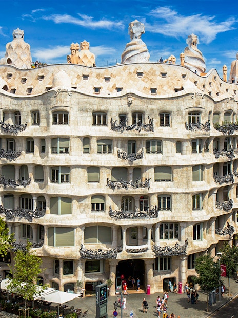 Casa Mila rooftop with unique chimneys in Barcelona, showcasing Gaudi's architectural design.