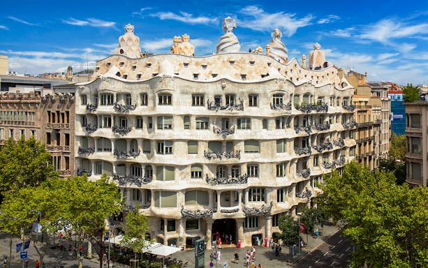 Casa Mila rooftop with unique chimneys in Barcelona, showcasing Gaudi's architectural design.