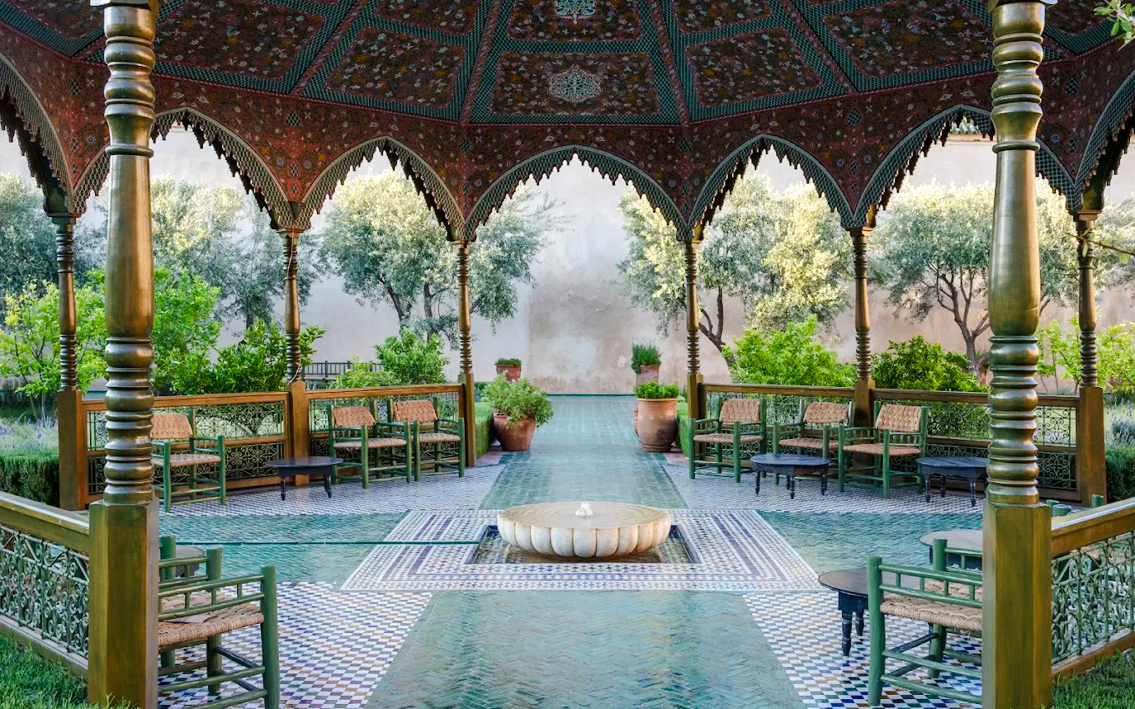 Le Jardin Secret courtyard with ornate arches and lush greenery in Marrakech, Morocco.
