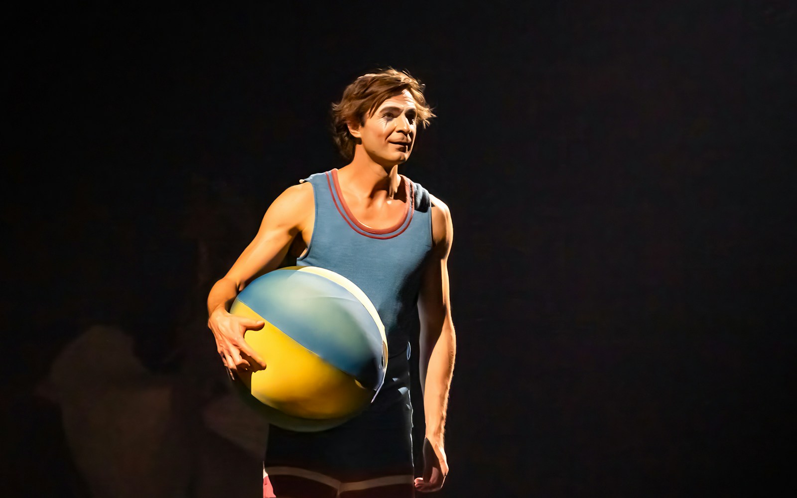 Performer holding a large ball during Cirque du Soleil: Corteo show.