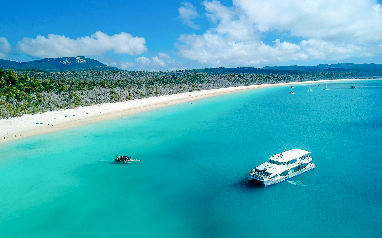 Boat near Whitehaven Beach, Whitsundays, with Great Barrier Reef in the background.