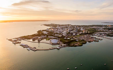Aerial view of Darwin cityscape and coastline during sunset, Northern Territory, Australia.