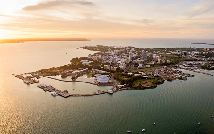 Aerial view of Darwin cityscape and coastline during sunset, Northern Territory, Australia.