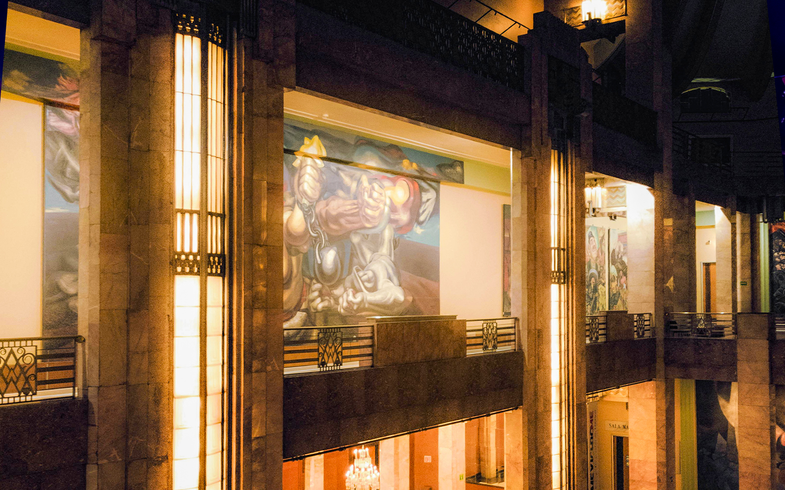Interior view of Palacio de Bellas Artes upper floor showcasing intricate murals and architectural details in Mexico City.