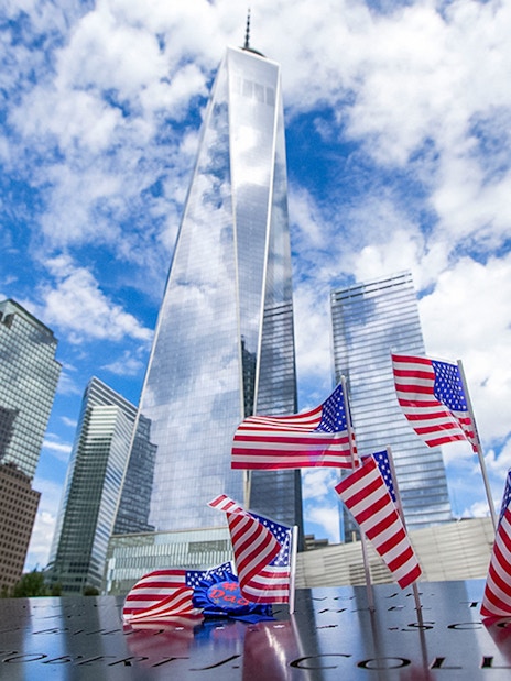 #USA flags at 9/11 Memorial with One World Trade Center in New York City.