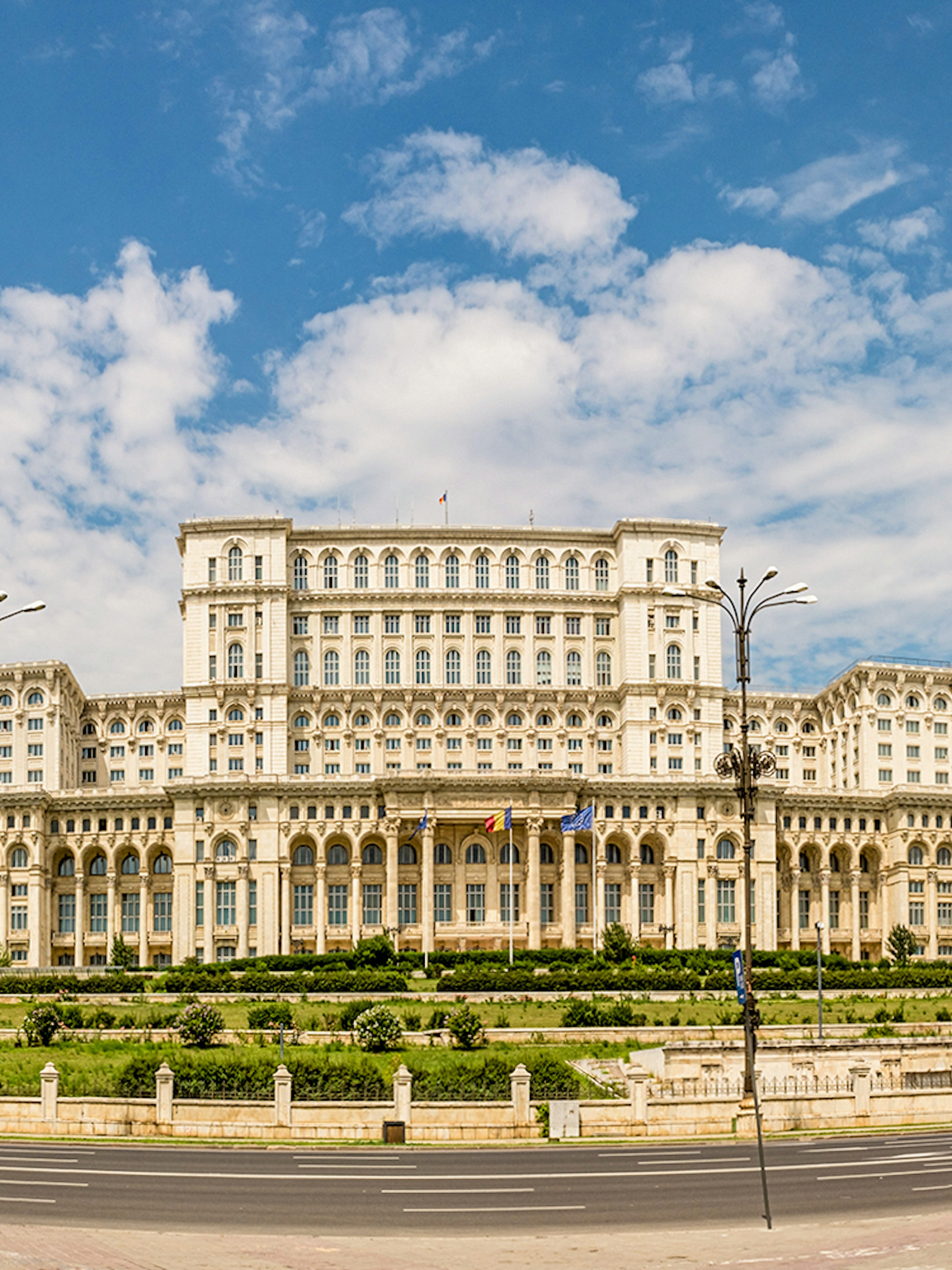 Palace of Parliament in Bucharest under a blue sky.