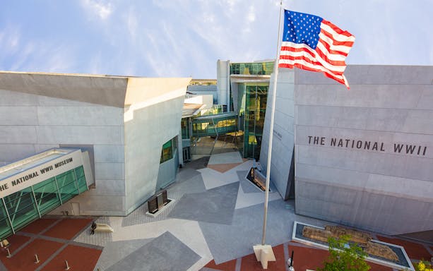 National WWII Museum entrance in New Orleans with American flag.