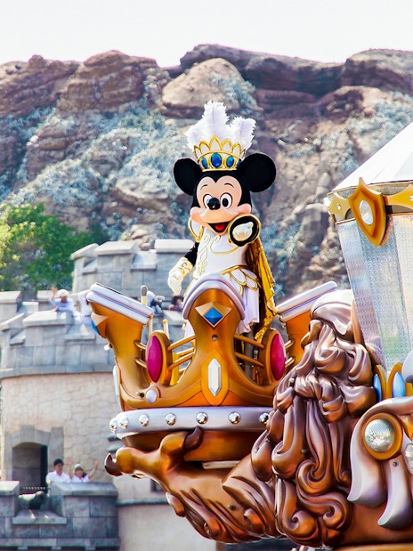 Mickey Mouse in royal attire on a parade float at Tokyo Disneyland.