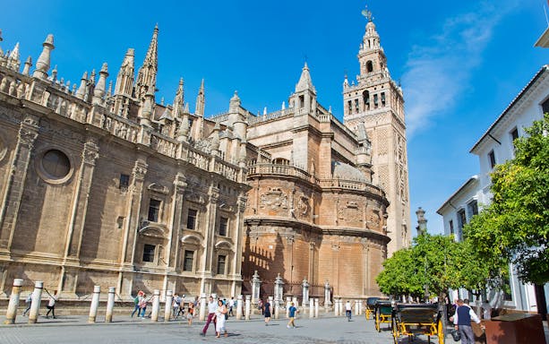Seville Cathedral and Giralda Tower on a sunny day during a Segway tour.