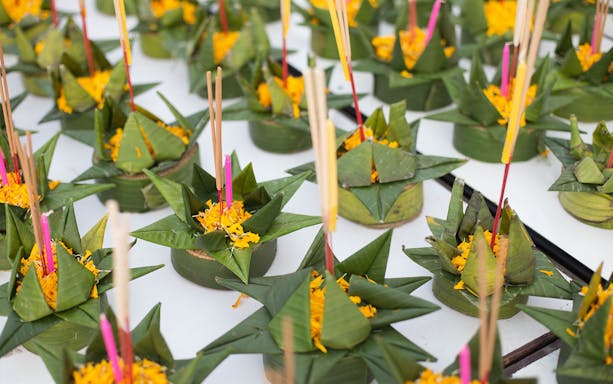 Banana leaf krathongs with marigold petals and incense sticks at Yeepeng Lanna Festival 2023.