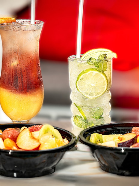 Fruit salad bowls and cocktails inside Szechenyi Bath Palm House.